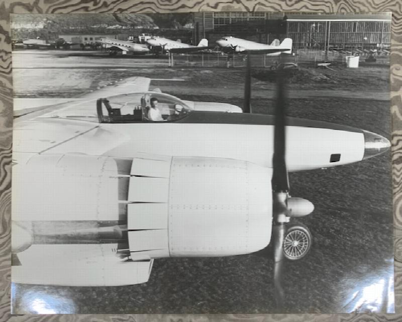 Image for [Howard Hughes sitting in the cockpit of the second FX-11 prototype, propellers spinning]